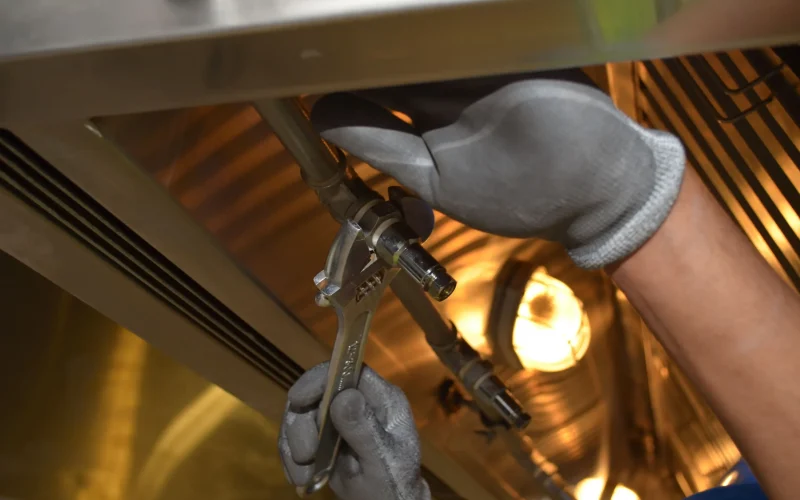 Professional plumber repairing damaged water pipes
